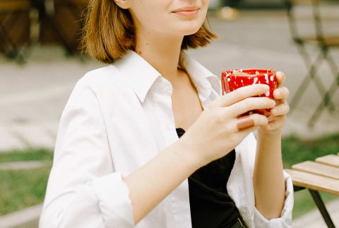 Woman Enjoying Coffee At Cafe