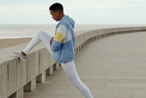 Woman exercising outside by the ocean / beach during fall / winter