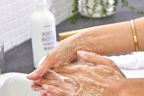 Woman washing her hands with mindbodygreen post biotic handwash Woman washing her hands with mindbodygreen post biotic handwash