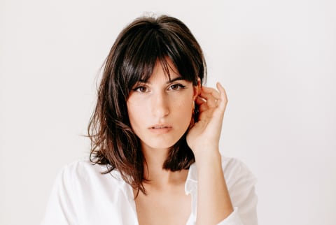 Portrait Of Brunette Young Woman Posing In Studio With Natural Light