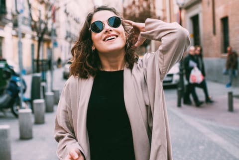 Woman walking down the street joyful