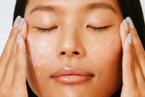 Woman Applying Face Lotion - Natural Skincare