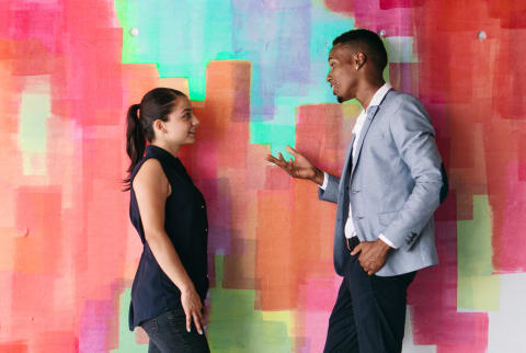 Couples talking about the elections in front of mural