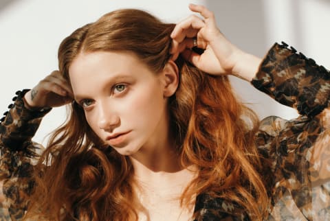 Woman touching her hair Woman touching her hair