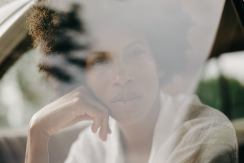 Black Woman Looking Out A Car Window