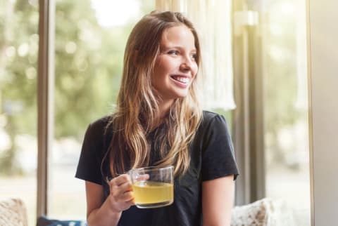 Young woman drinking green tea