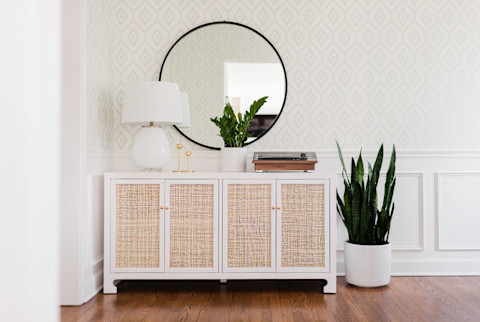 Sideboard table in dining room with record player, brass candlesticks, and plants Sideboard table in dining room with record player, brass candlesticks, and plants