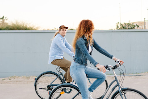 Young Couple On Bicycles In City