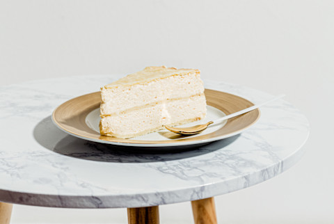 Slice of White Layer cake on a Plate in a Minimal Setting Slice of White Layer cake on a Plate in a Minimal Setting
