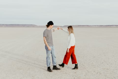 Man And Woman Dancing In A Desert