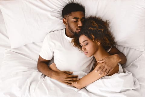 Couple Laying Together in Bed