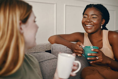 two women drinking coffee