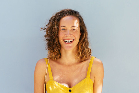 Smiling Woman Wearing Yellow Dress On The Street. Smiling Woman Wearing Yellow Dress On The Street.