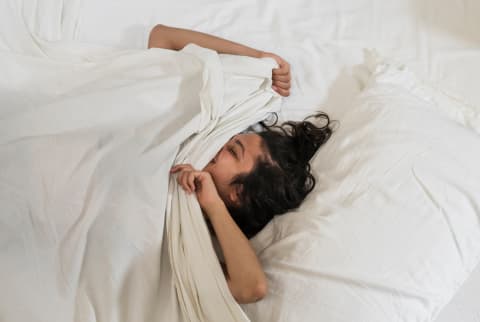 Is It Normal To Move Around A Lot At Night? We Asked A Sleep Specialist