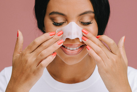 Woman Applying a Nose Strip Woman Applying a Nose Strip
