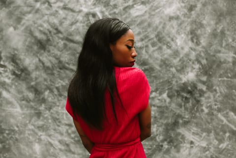 Profile Portrait Of Woman Posing Over Grey Background