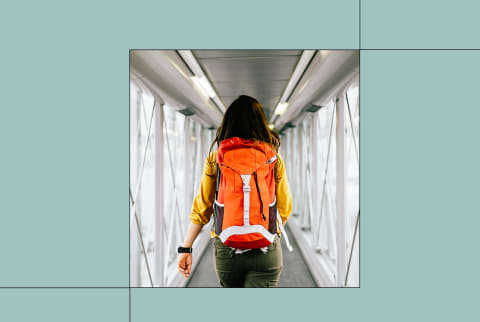 women walking onto airplane with backpack