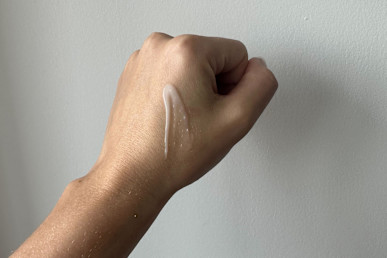 Adwoa Beauty Melonberry Hair Milk Leave-In Conditioner in tester's hand.