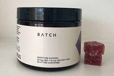 batch nighttime gummies on counter next to two gummies