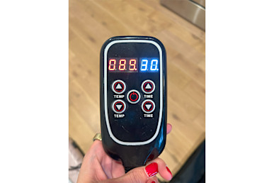 Bon Charge Infrared Sauna Blanket controller held by tester's hand