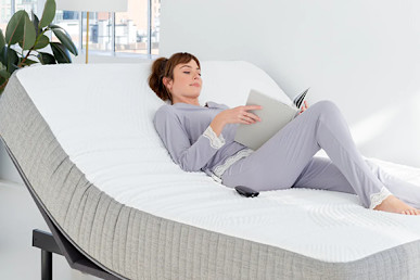 Brentwood Home Cypress Memory Foam Mattress in living room and person is lying on it while reading