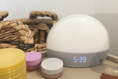 Hatch Restore 1 on nightstand next to lotion and lip mask