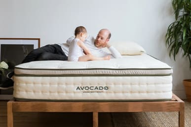 Avocado vegan mattress in bedroom with father and son on it