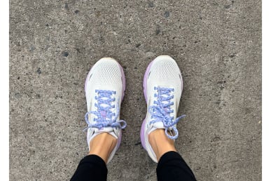 Brooks Ghost 15 Running Shoe Review with white and purple on runners feet on sidewalk side by side