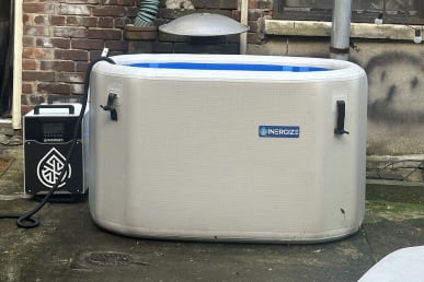 Inergize tub next to chiller with hose adding water
