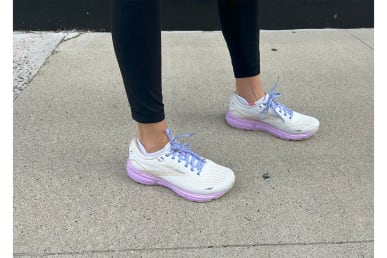 Brooks Ghost 15 Running Shoe on feet on sidewalk with leggings