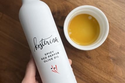 bottle of kosterina spicy red pepper best olive oil on table bottle of kosterina spicy red pepper best olive oil on table