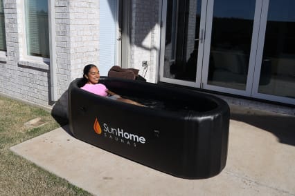 Sun Home Sauna Setup with reviewer in tub