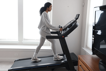 Horizon 7.0 Treadmill at slightly incline in living room with tester walking