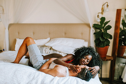 bi-racial couple in bed together bi-racial couple in bed together