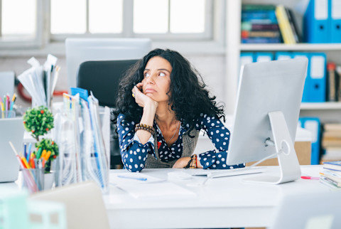 Woman zoning out at work 