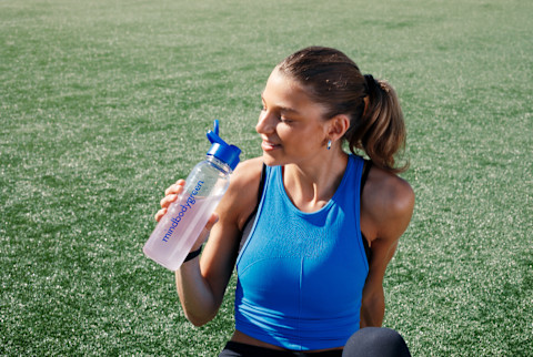 woman drinking water outside woman drinking water outside