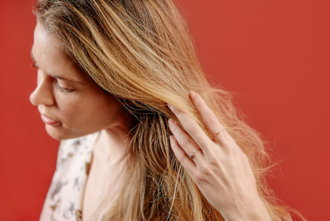alexandra engler with her hair down on a red background