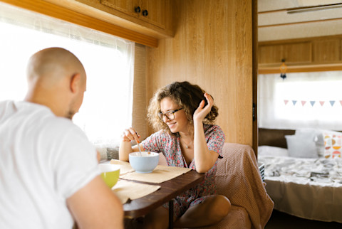 Young Couple Having Breakfast In A Trailer