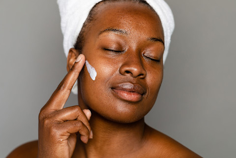 Woman Applying Face Lotion
