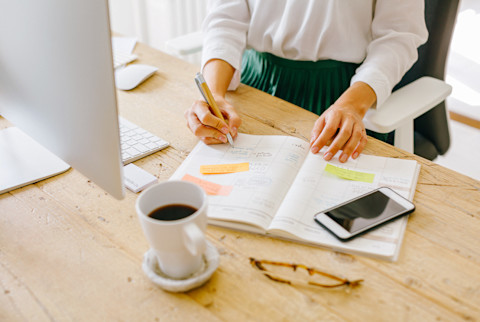 Unrecognizable Woman Working at Her Desk