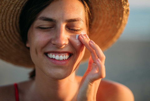 Woman applying sunscreen Woman applying sunscreen