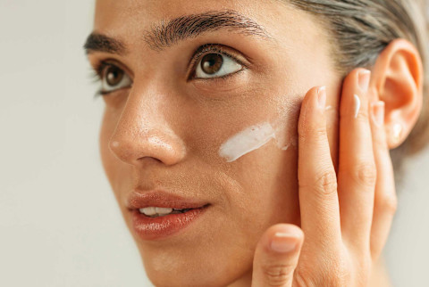 Beautiful and fresh looking woman putting on skin care Beautiful and fresh looking woman putting on skin care