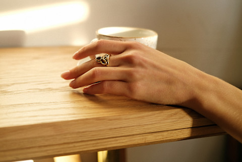 Unrecognizable woman holding cup in sunny room Unrecognizable woman holding cup in sunny room