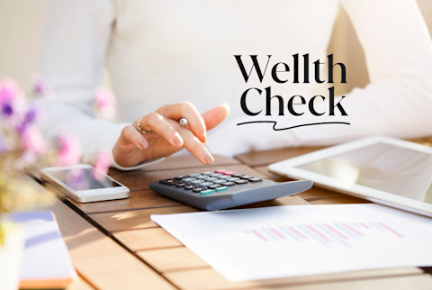 Wellth Check: Someone organizing their finances with a calculator Wellth Check: Someone organizing their finances with a calculator