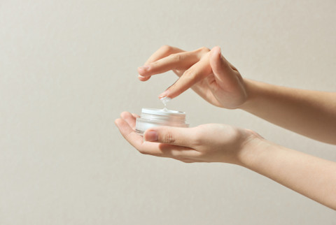 Woman Applying Cosmetic Cream