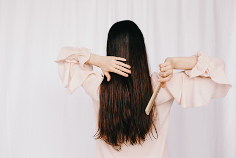 woman brushing long brown hair woman brushing long brown hair