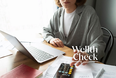 Wellth Check: A woman doing her taxes Wellth Check: A woman doing her taxes