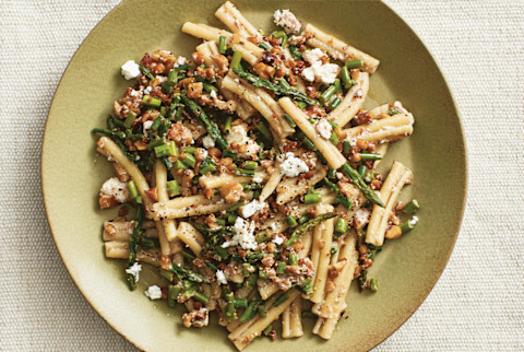 Pasta dish with rosemary walnuts and feta on a green plate Pasta dish with rosemary walnuts and feta on a green plate