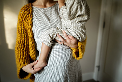 Pregnant woman holding older child