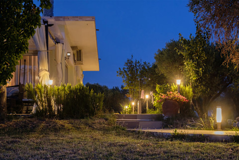 Yard and bungalow lit by lanterns. Night on the sea coast. stock photo Yard and bungalow lit by lanterns. Night on the sea coast. stock photo